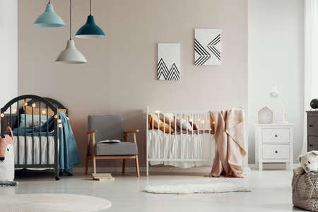 Stylish kid's bedroom interior with elegant wooden furniture and posters on the wallの写真素材