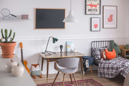 Mid century furniture in genderless white bedroom for kidの写真素材