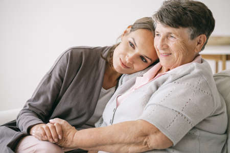 Young woman hugging her older grandmotherの写真素材