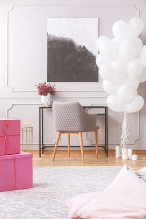 Pink boxes with presents on floor of elegant room ready for birthday hooplaの写真素材