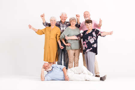 Portrait of group of senior friends having funの写真素材