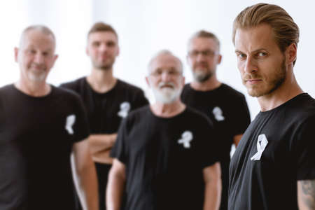 Group of men wearing white ribbons protesting against violenceの写真素材