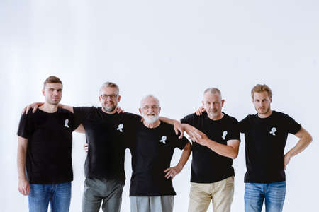 Group of men wearing black with white ribbons on t-shirtsの写真素材