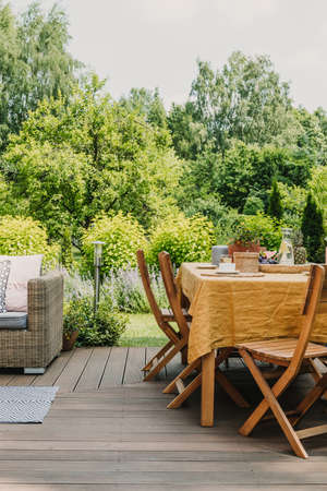 Elegant garden furniture on terrace of suburban home