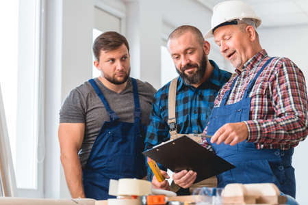 Group of professional contractors analyzing the house projectの写真素材