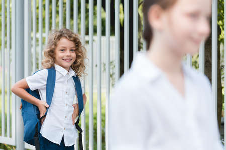 Young happy boy wearing backpack walking to schoolの写真素材