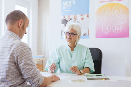 Dietician and her patient planning his diet togetherの写真素材