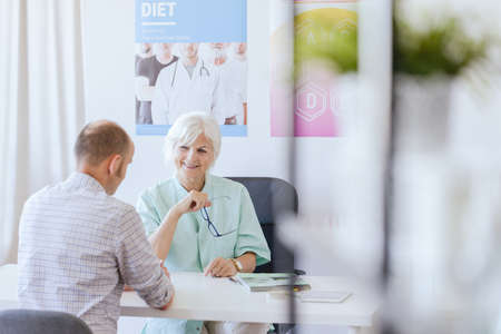 Man in the nutritionist's office talking about losing the weight