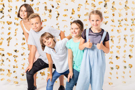 Group of cool girls fooling around and making funny poses during new year's partyの写真素材