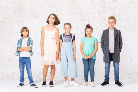 Group of happy children is standing together in a room