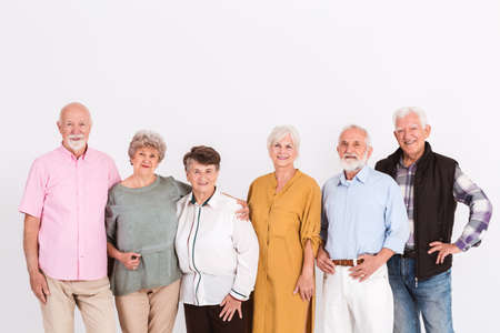 White interior with group of senior happy people in casual clothsの写真素材
