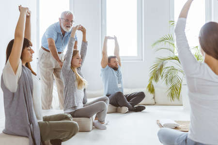 Group of young people breathing in and out during bioenergy therapyの写真素材