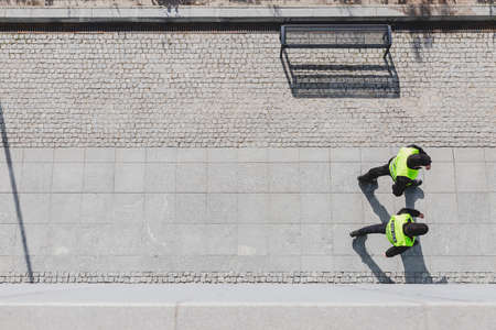 Top view of two police officers walking down the streetの写真素材