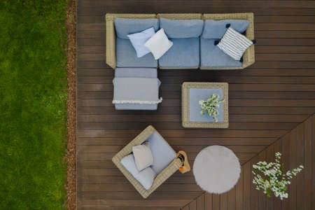 Top view of wooden terrace with comfortable wicker garden furnitureの写真素材