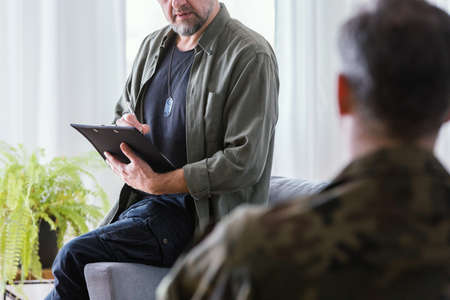 War psychologist talking with his patient about the army