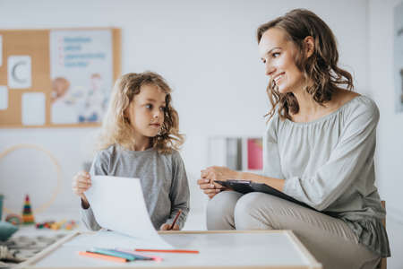 Little boy and his speech therapist at schoolの写真素材