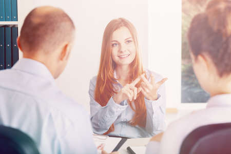 Confident young woman pointing her advantages during the recruitment interviewの写真素材