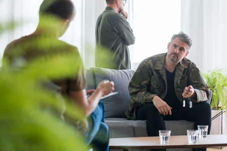 Middle aged soldier with ptsd at psychotherapist