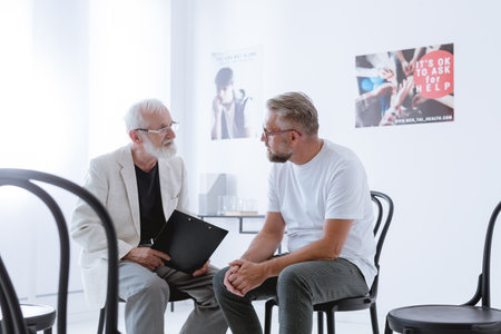 Psychotherapist discussing with the patient his behaviorの写真素材