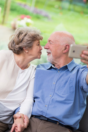 Older married couple kissing for a pictureの写真素材