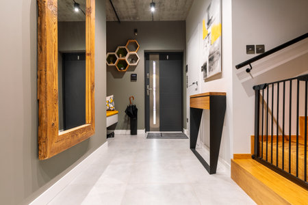 Trendy corridor with big mirror in wooden frame and console tableの写真素材