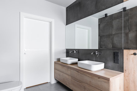 Double sinks in elegant white, concrete and wooden bathroom interiorの写真素材