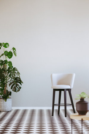 Trendy armchair in modern living room interior with gray wall and black and white floorの写真素材