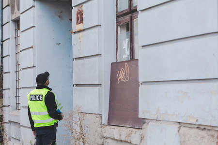 Policeman during patrolling checking the address of the suspectの写真素材
