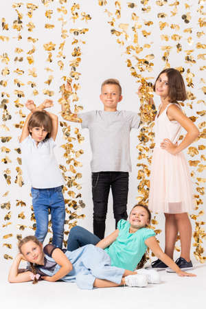 Group of cool girls fooling around and making funny poses during new year's partyの写真素材