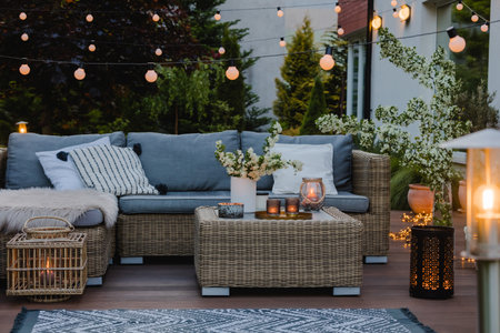 Summer evening on the patio of beautiful suburban house with gardenの写真素材