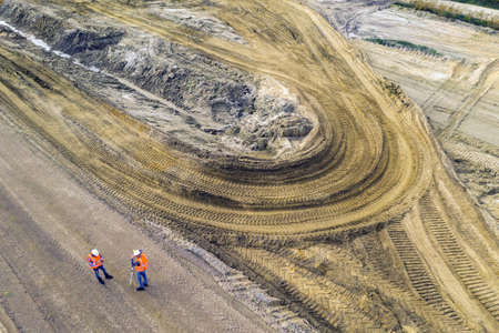 Two geodesists checking the construction site before buildingの写真素材