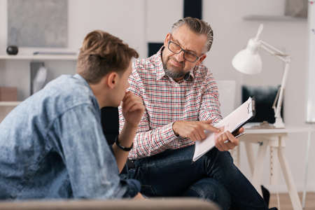 Young man and his coach talking about life -work balanceの写真素材