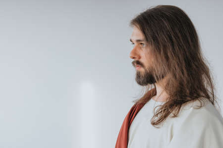 Picture of Jesus Christ wearing white and red robes standing on a white backrgoundの写真素材