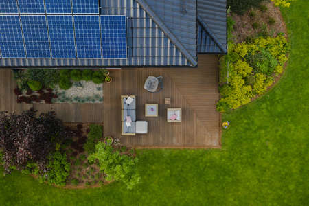 Top view of suburban house with green garden and wooden terraceの写真素材