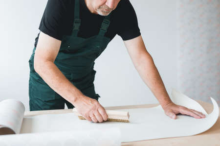 Boss of renovation crew with plans of refreshing old apartmentの写真素材