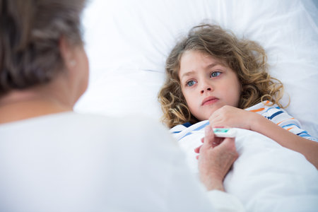 Grandmother taking care of her sick small grandsonの写真素材