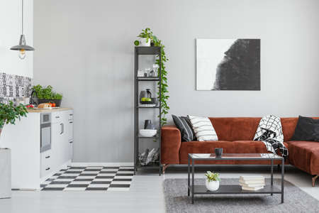 Scandinavian style in spacious living room with comfortable brown corner sofaの写真素材