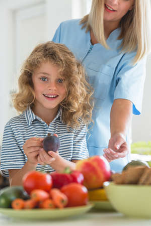 Helpful dietitian holding the chock, preparing healthy diet plan for her patientsの写真素材