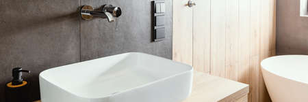 Double sinks in elegant white, concrete and wooden bathroom interiorの写真素材