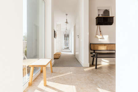 Stylish retro furniture in elegant bright corridor of trendy homeの写真素材