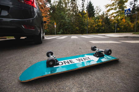 Flipped over skateboard on the road after the accident