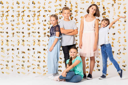 Group of cool girls fooling around and making funny poses during new year's partyの写真素材