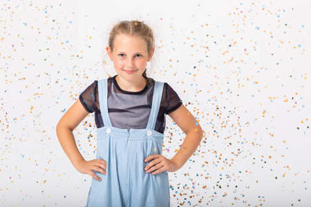Cute teenage girl smiling and standing in empty room, copy space on empty wallの写真素材