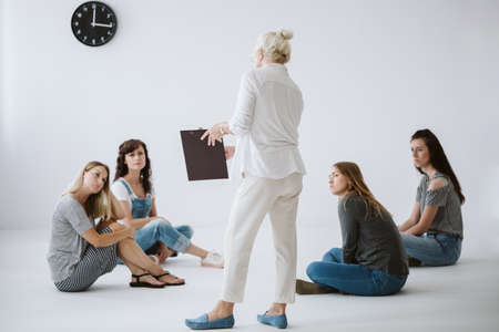 Senior psychotherapist writes the rules of group consultations for women on legal padの写真素材