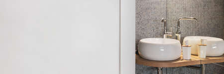 Empty wall in stylish bathroom interior with two sinks and lampsの写真素材
