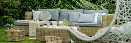 Modern designed green garden with rattan furniture