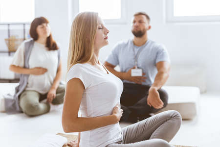 Young woman practicing the bretahing suring bioenergy therapy session