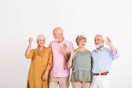Group of for elegant senior happy people in white interiorの写真素材