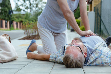 First aid to an accident victim lying on the streetの写真素材