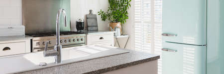 Bright white open ln kitchen interior in stylish home for single familyの写真素材